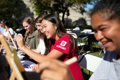 Smiling students in a painting class on the grounds of the IU Kokomo campus.